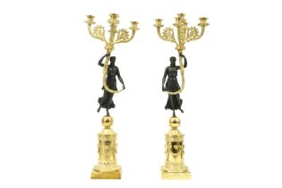 pair of Empire style candelabra in partially gilded bronze each with a typical female figure || Paar