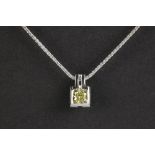 a 0,60 carat natural fancy yellow high quality rectangular modified brilliant cut diamond set in a