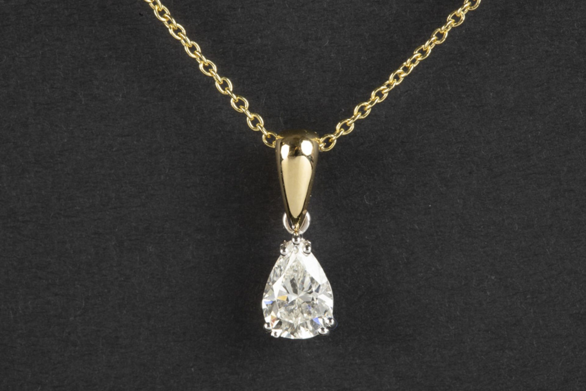 a 1,26 carat high quality oval brilliant cut diamond set in a pendant in white and yellow gold (18