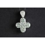cross-shaped pendant in white gold (18 carat) with ca 0,60 carat of white and fancy blue quality