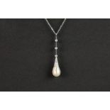natural pearl set on an antique pendant in platinum with high quality old brilliant and rose cut