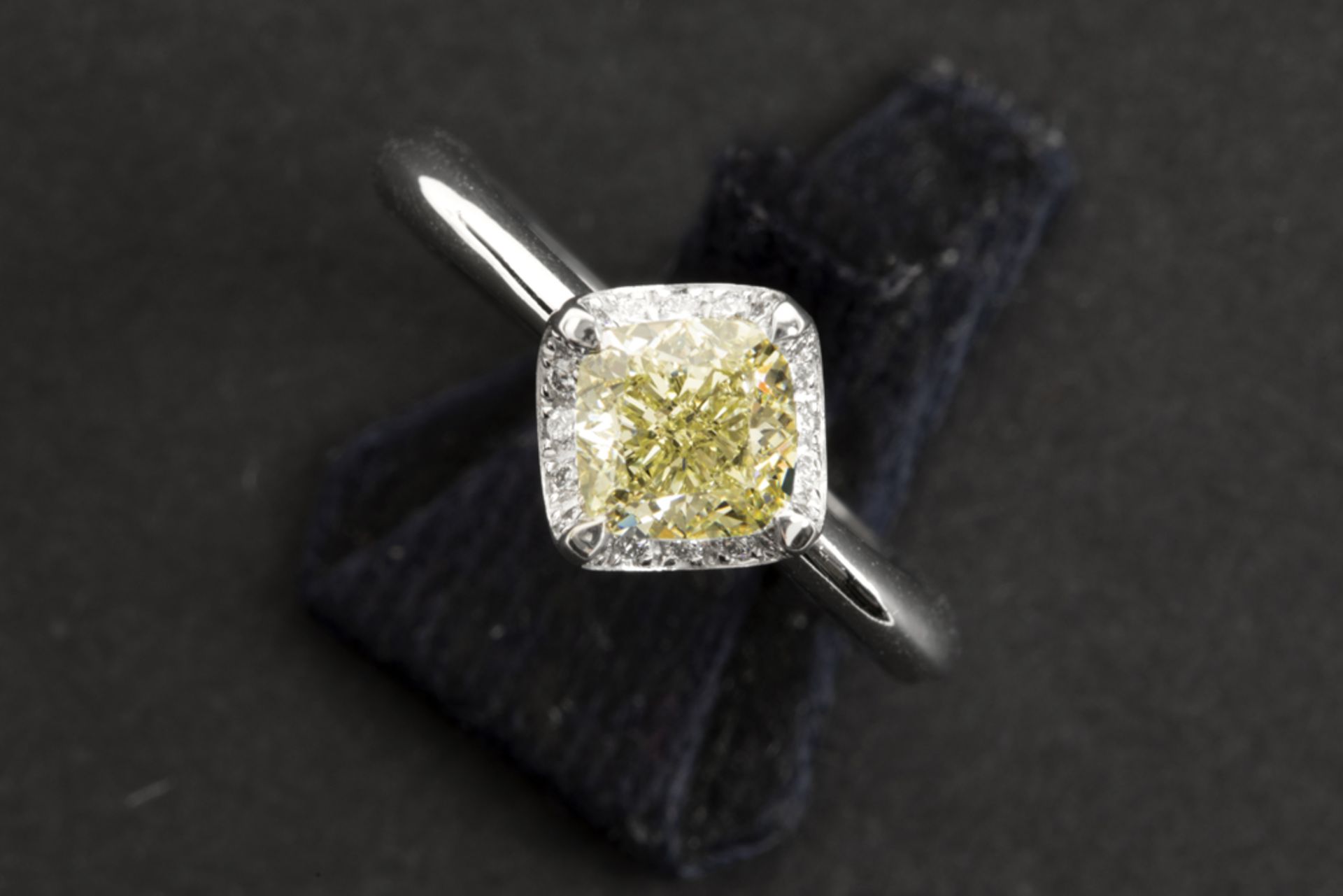 a 1,38 carat fancy yellow high quality princess' cut diamond set in a ring in platinum with ca 0,