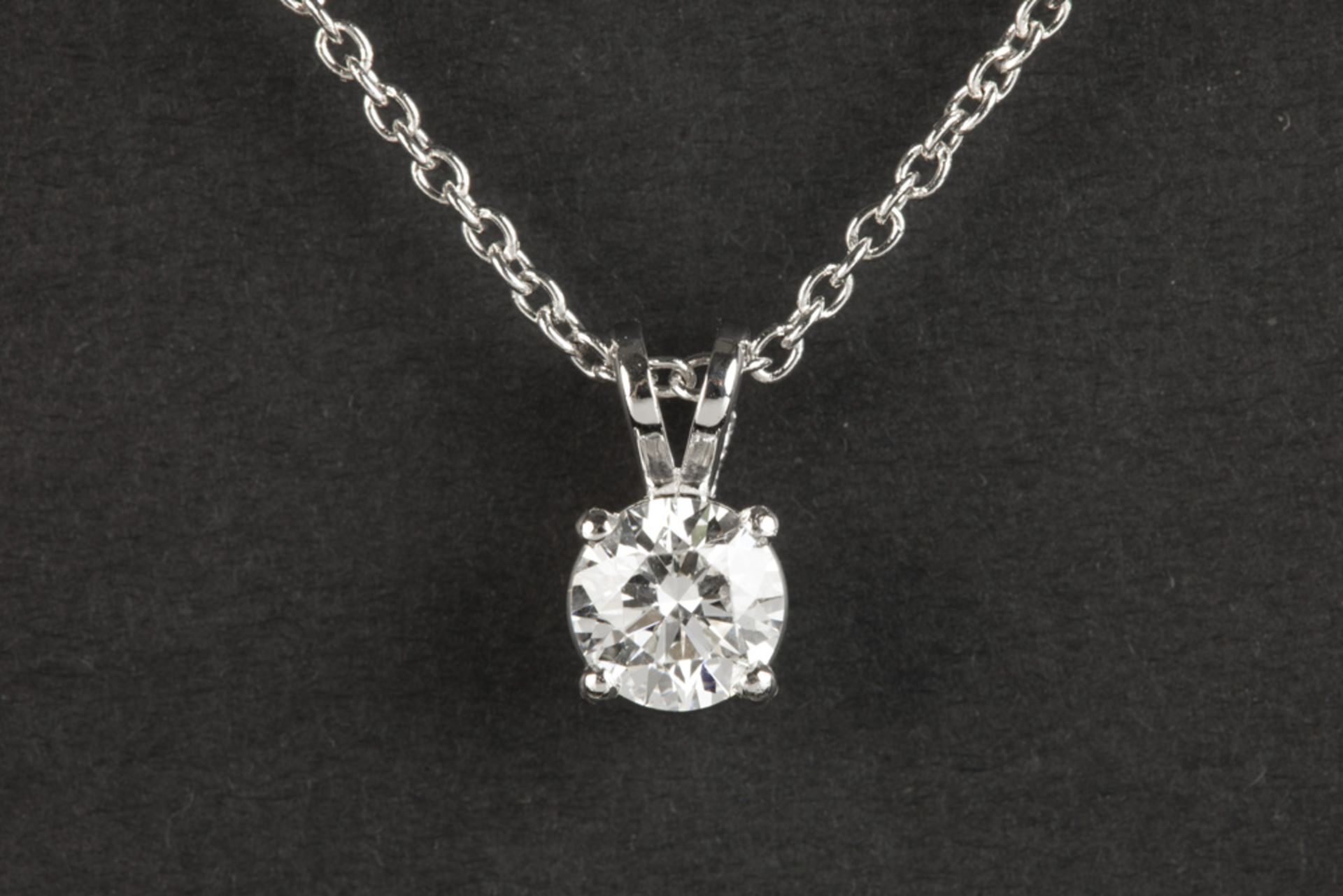 a 0,69 carat CVD high quality brilliant cut diamond set in a pendant with its chain in white gold (
