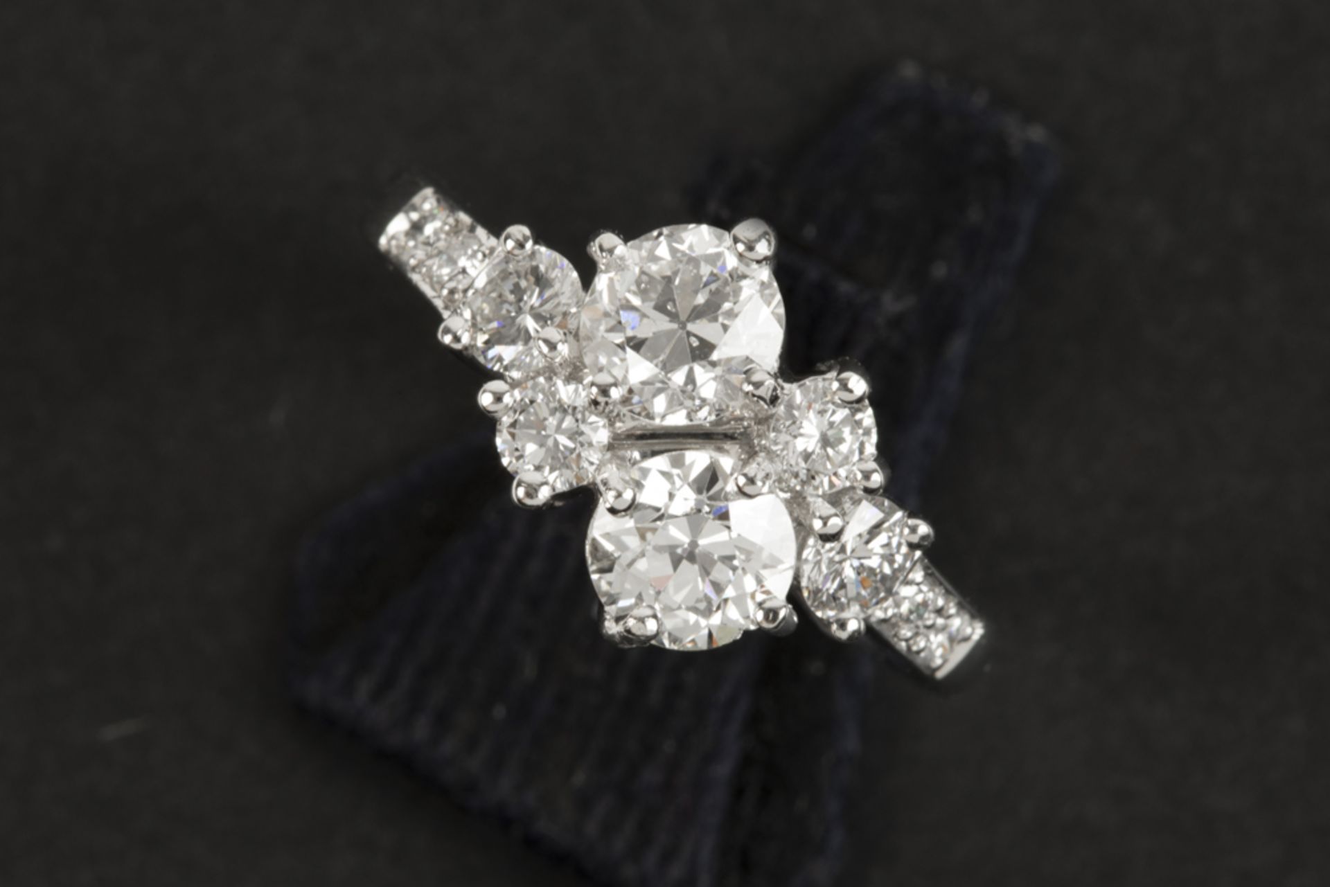 ring in white gold (18 carat) with two bigger quality old brilliant cut diamonds, weighing ca 1,30