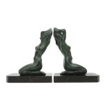 pair of French Art Deco book-ends in marble each with a sculpture with typical green patina ||