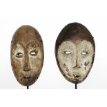 two African Congolese 'Lega' masks in wood with typical shape and features || AFRIKA - KONGO - 1°