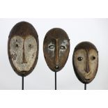 three African Congolese 'Lega' masks in wood with typical shape and features || AFRIKA - KONGO -