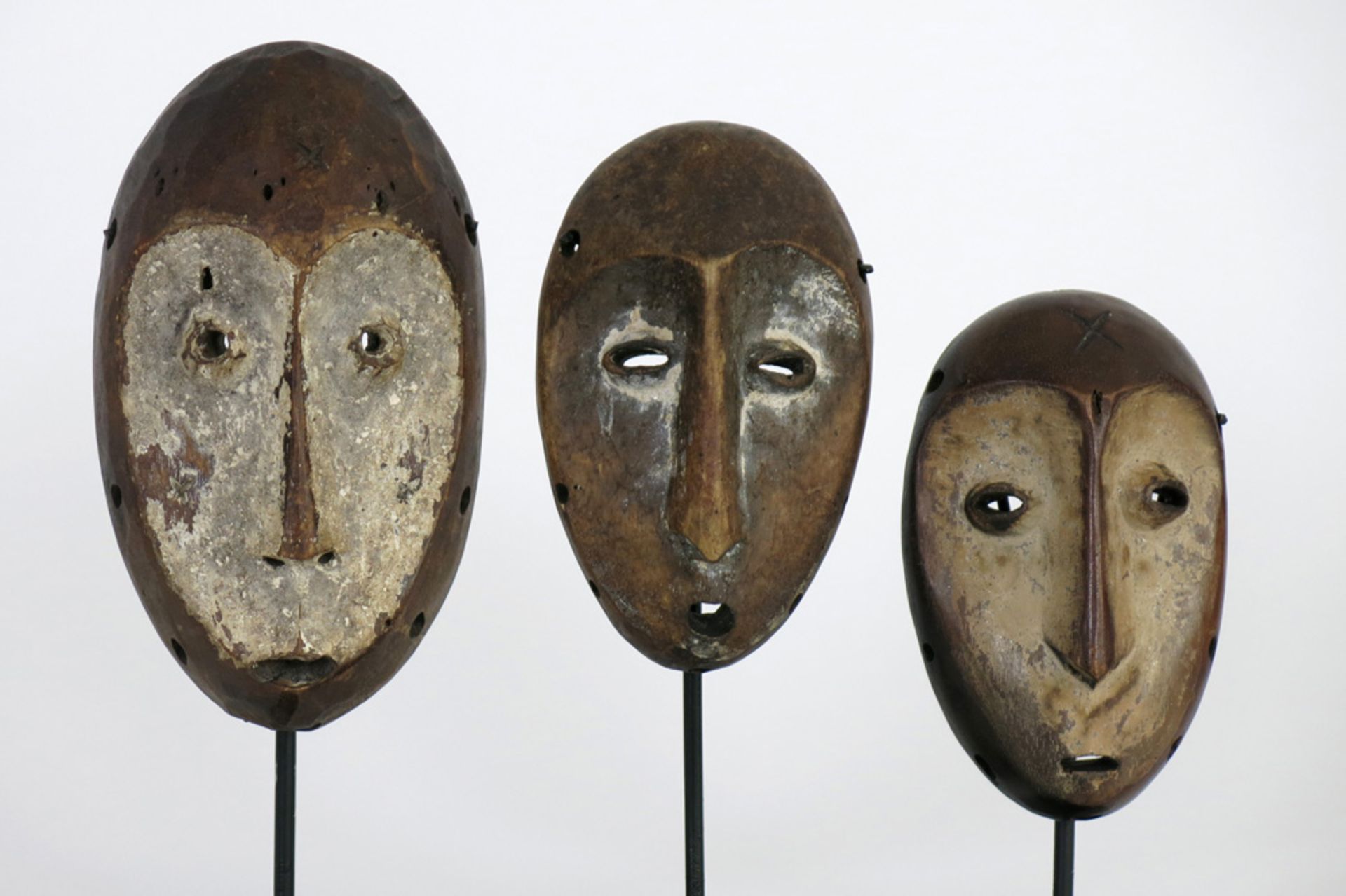 three African Congolese 'Lega' masks in wood with typical shape and features || AFRIKA - KONGO -