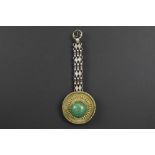 round antique Tibetan gilded ornament with fine perlage work and with a central green stone - with a