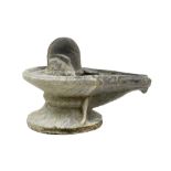 Indian stone sculpture in the shape of a lingam in a yoni (symbolizing the masculine and