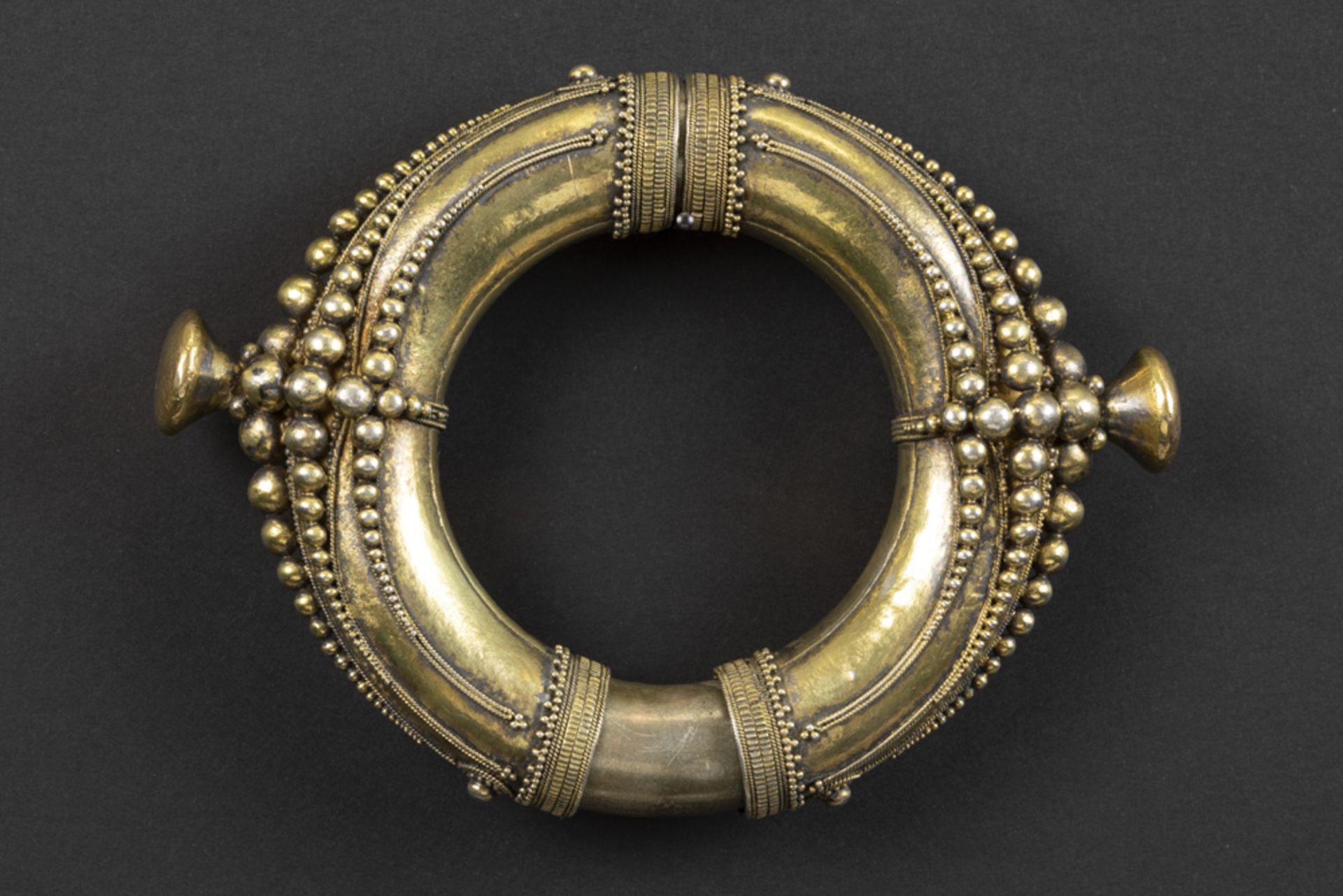 rare and antique Indonesian Sumatra bangle from the Batak with typical design in gilded silver -