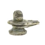 Indian stone sculpture in the shape of a lingam in a yoni (symbolizing the masculine and