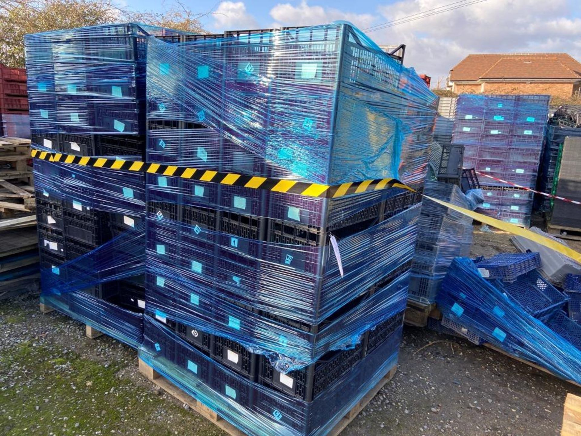 Five pallets of assorted plastic carry crates