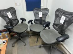 Three ergonomic swivel chairs with armrests