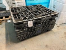 Seventeen assorted black plastic pallets