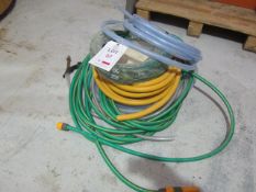 Two garden hose pipes and three reels of assorted pipe