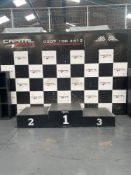 winners podium with first, second and third place sections complete with capital karts backdrop