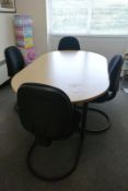 Light oak effect oval boardroom table, approx 1800 x 1000mm, and four black upholstered chairs