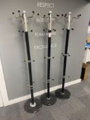 Three marble based metal framed coat stands