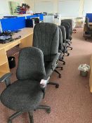 Seven various black swivel office chairs