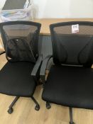 Two black upholstered swivel office chairs