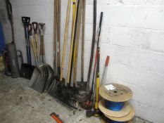 Two wheelbarrows, assorted hand tools including shovels, rakes, forks, two part reels of rope,
