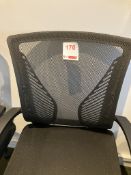 Three black upholstered swivel office chairs