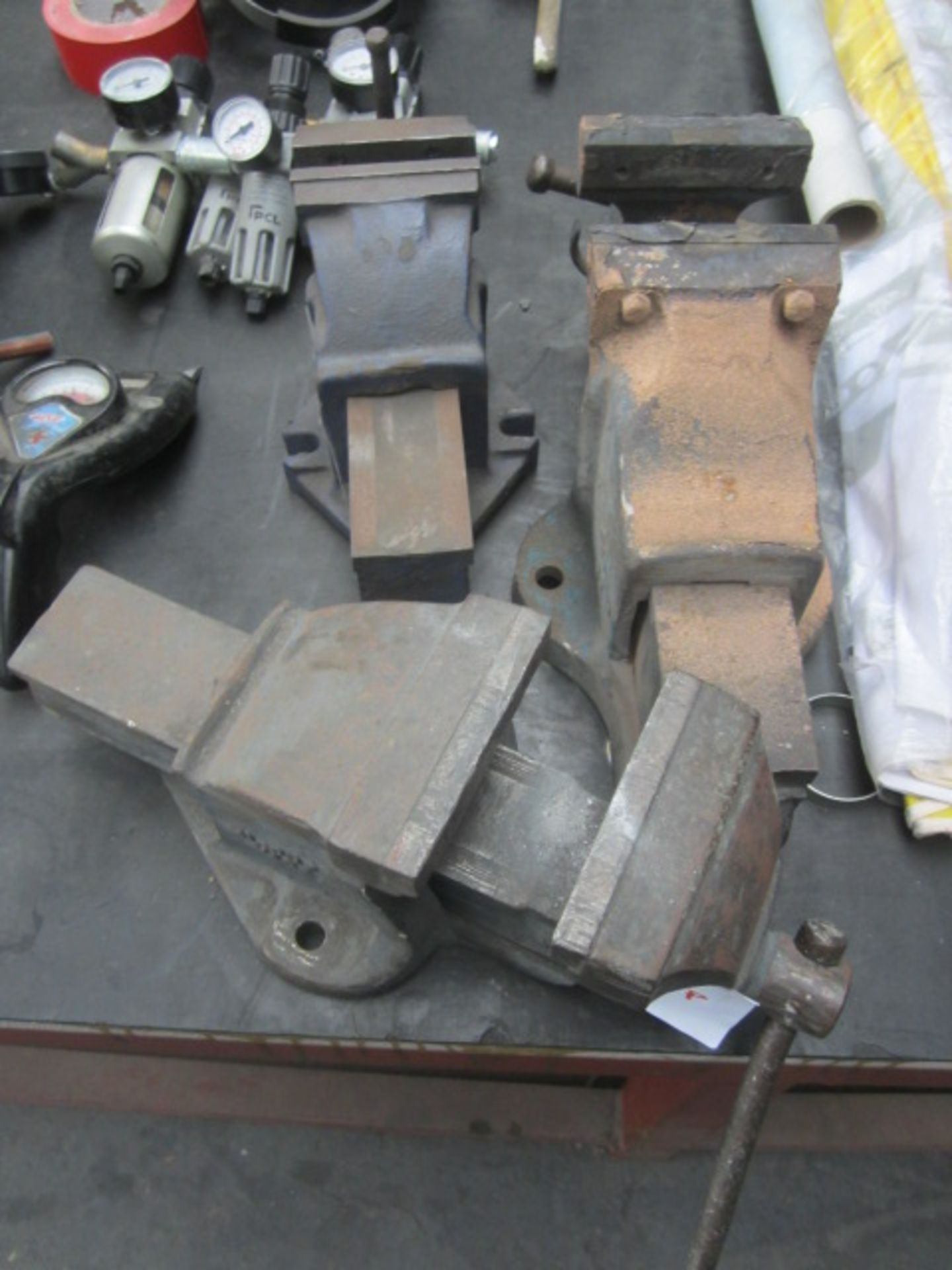 Three various bench vices