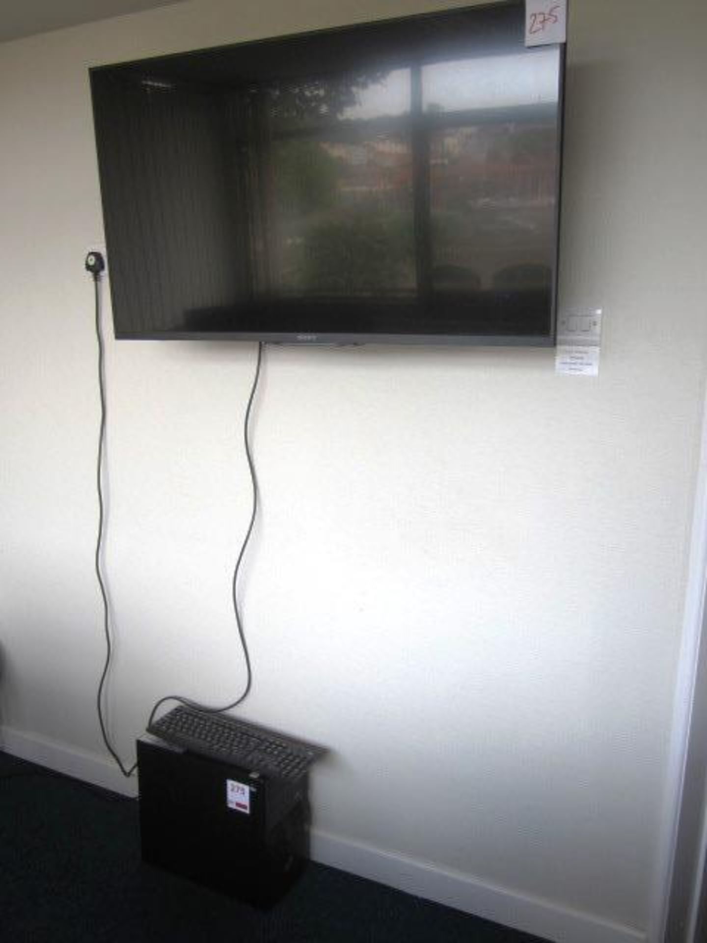 Sony Wall mounted monitor, model KDL-42W705B, Fujitsu computer tower and keyboard