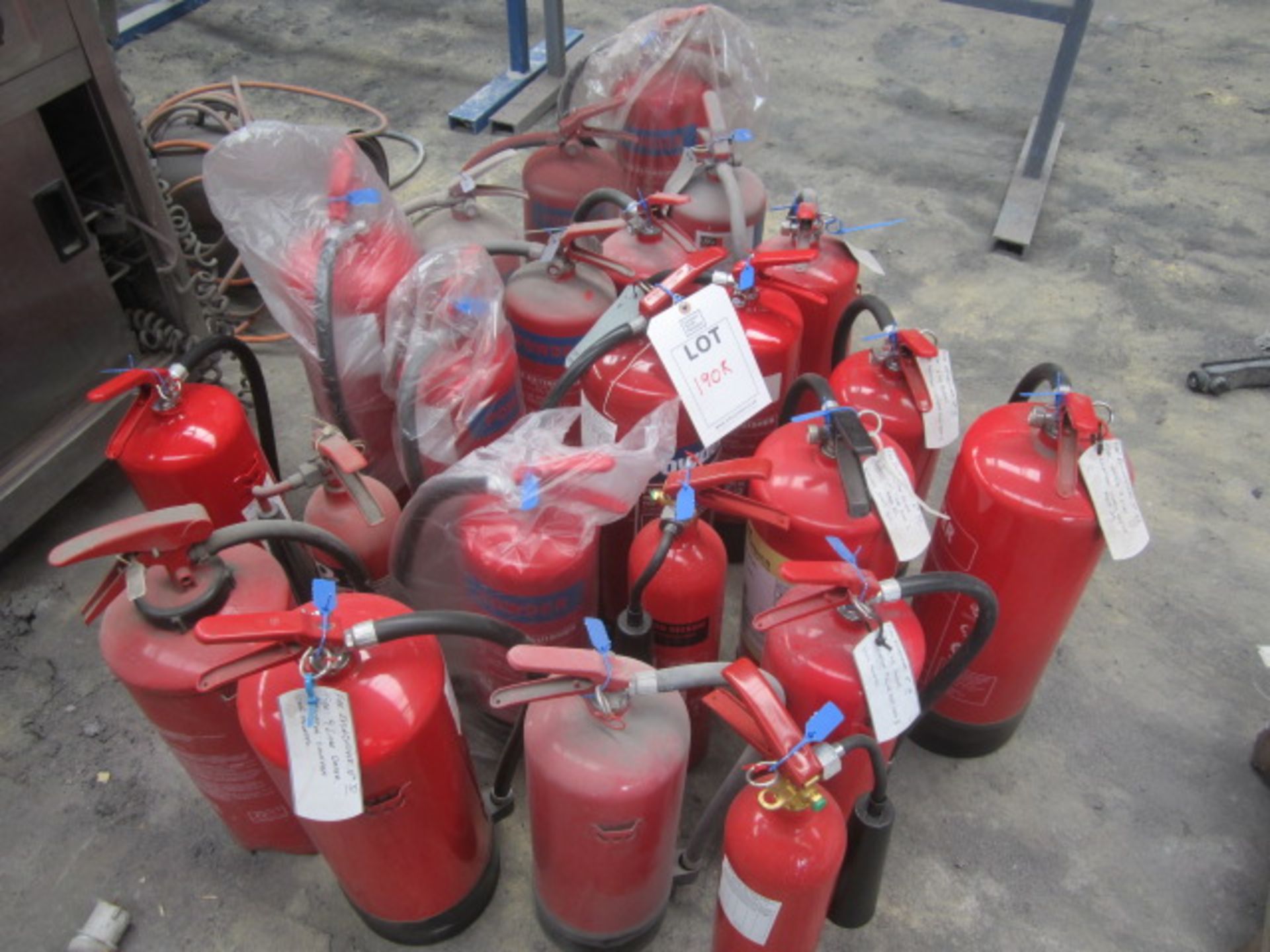 Quantity of assorted fire extinguishers including powder, foam, water etc.