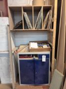 Two-door metal cabinet with various used saw blades