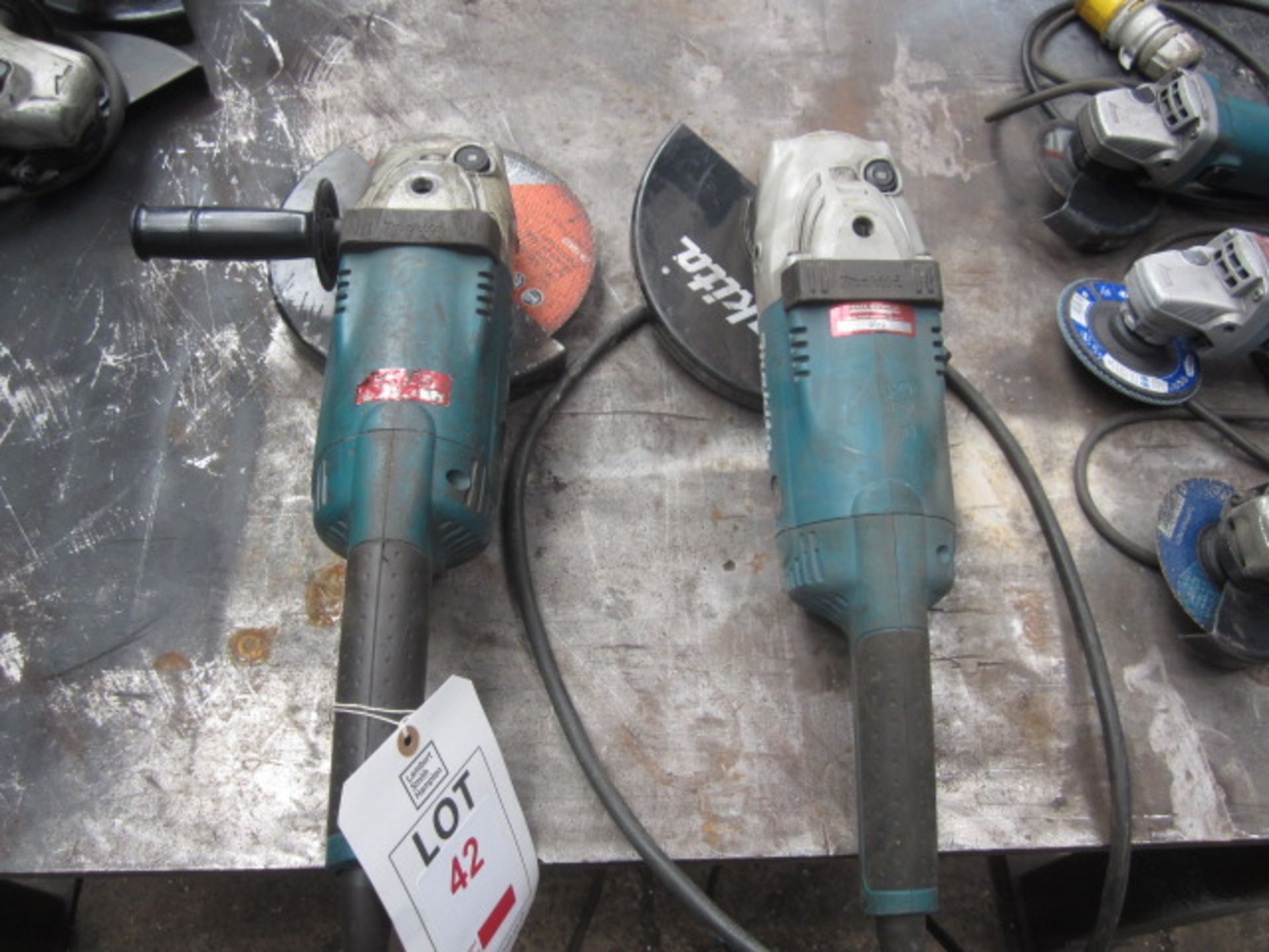 Two Makita 9" angle grinders, 110v