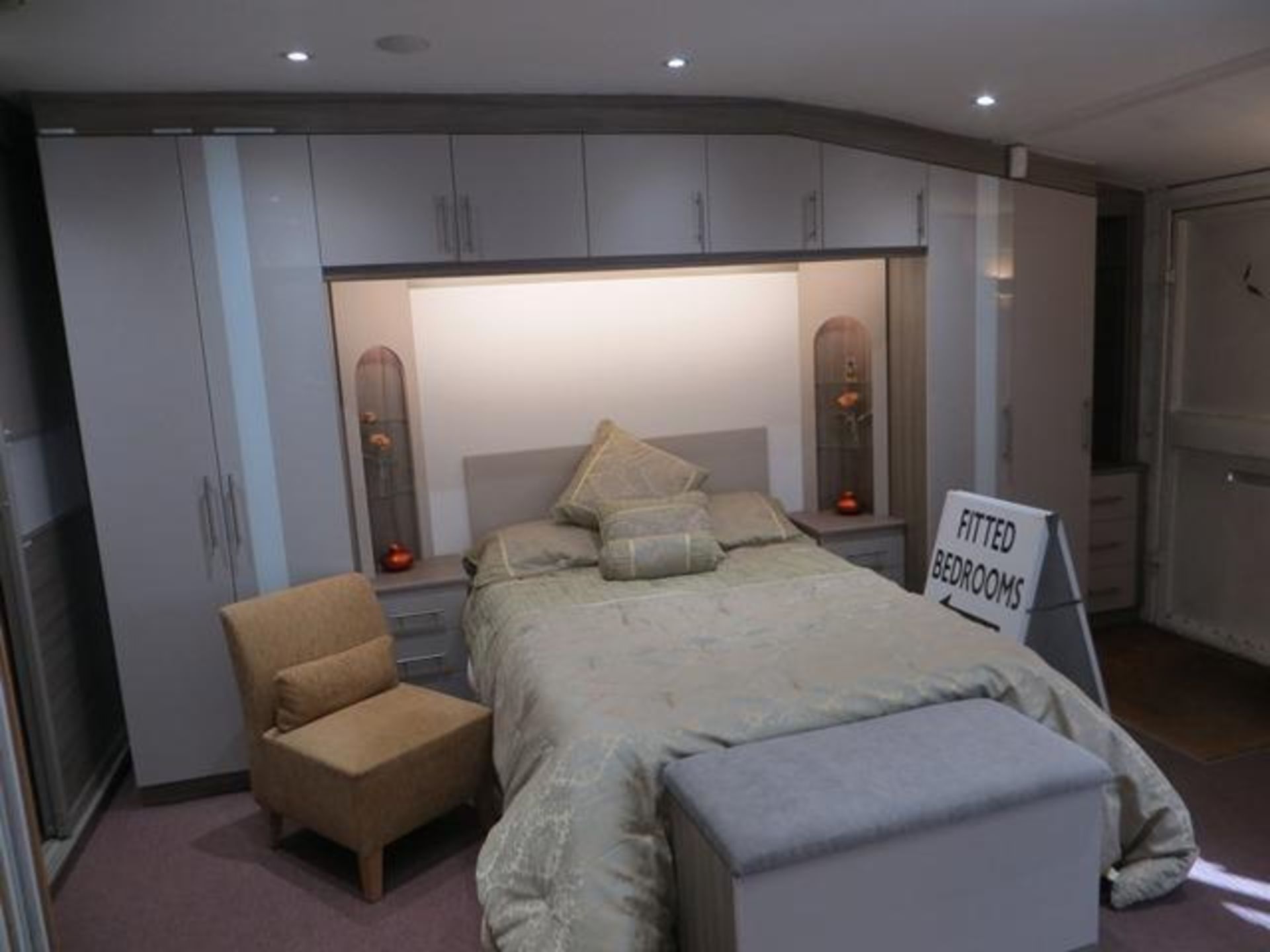 Bespoke installation bedroom suite comprising: 2-door wardrobe, 5-door bridge above bed with 2 bedsi