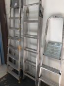 Three various aluminum stepladders and a set of mobile library style three-step