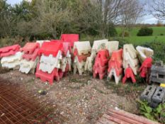 Approximately 80 red and white road barriers