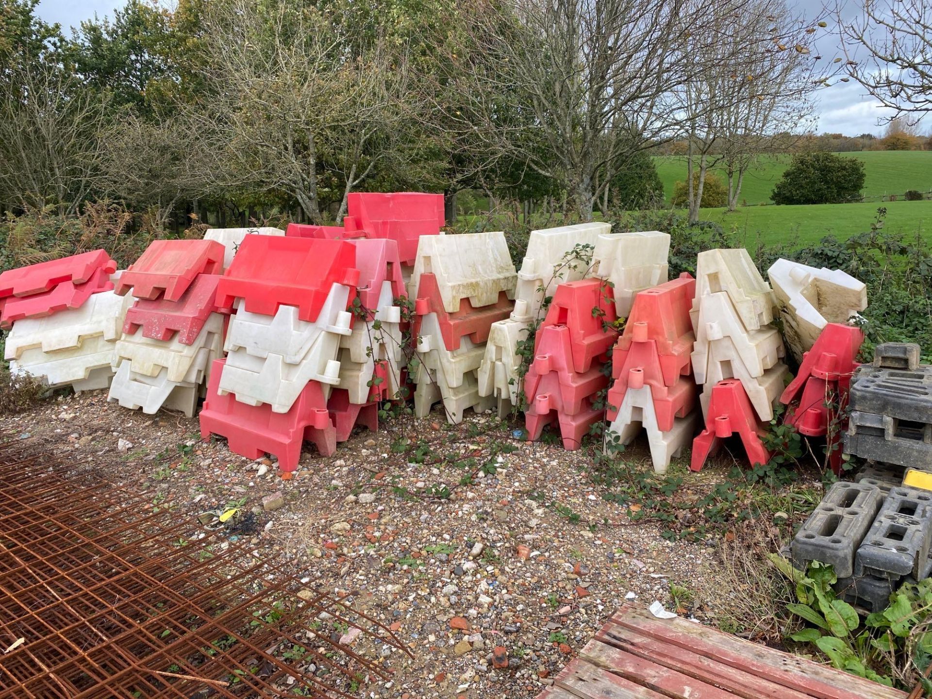 Approximately 80 red and white road barriers
