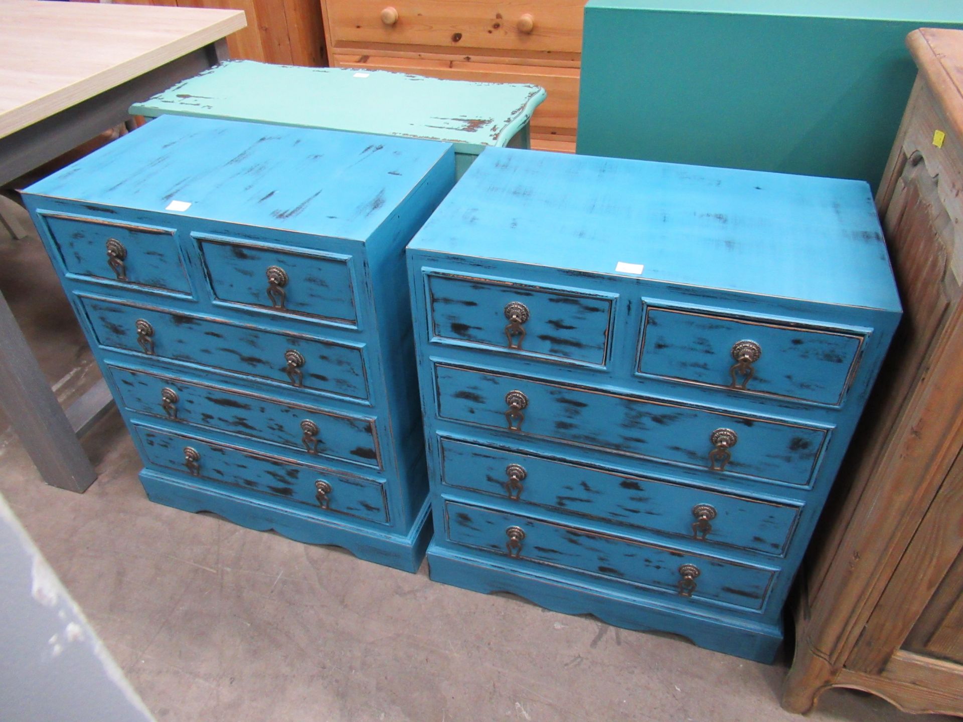Pair of rustic effect painted five drawer cabinets