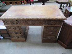 Nine drawer twin pedestal desk with leather inlaid top