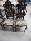 A pair of ebonised oriental themed chairs