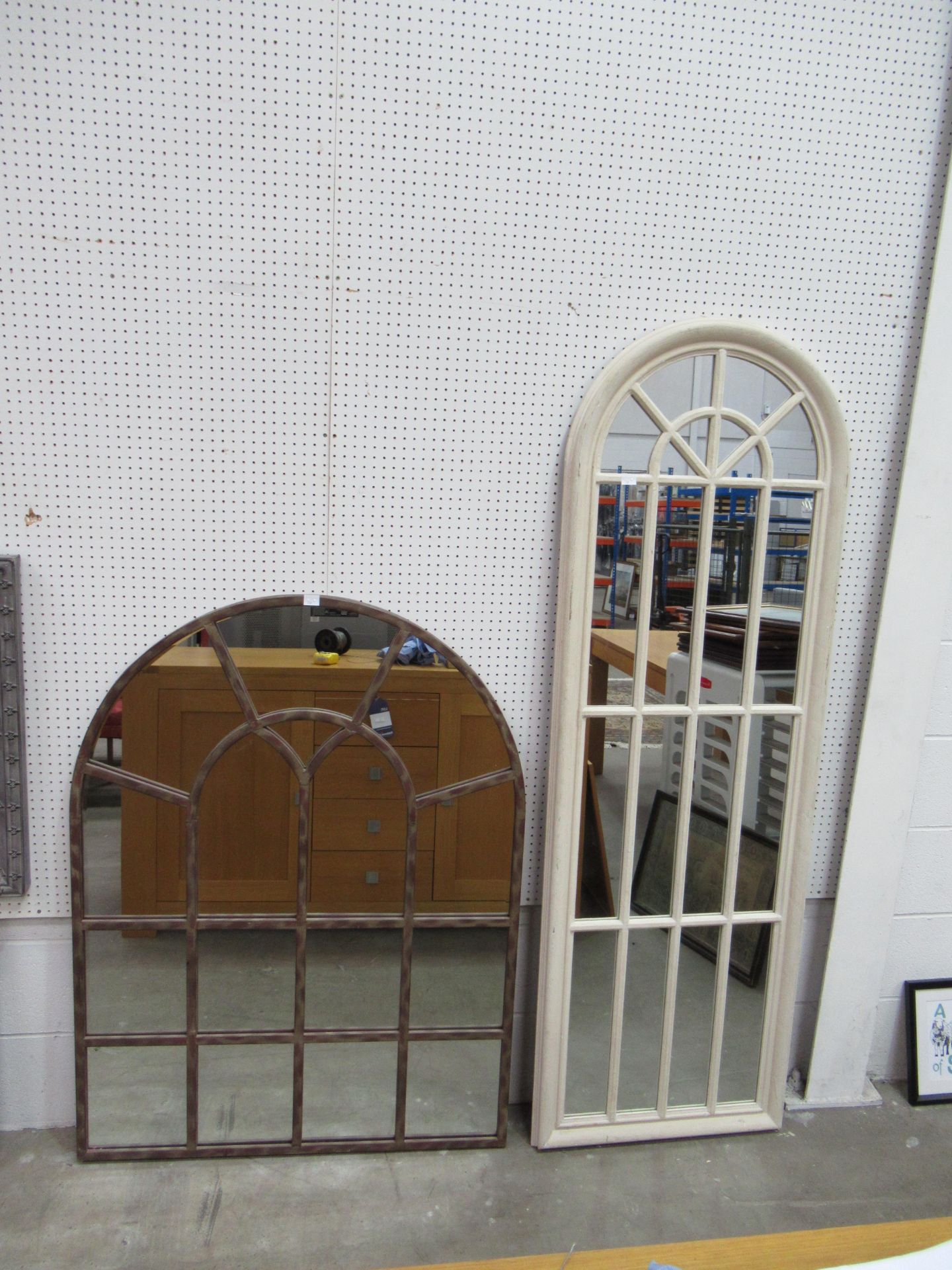 Rustic metal framed arch mirror and a wooden framed arch mirror