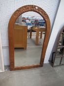 Wooden framed mirror in arch shape