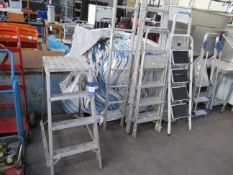 Assorted ladders including step ladders and platform ladders