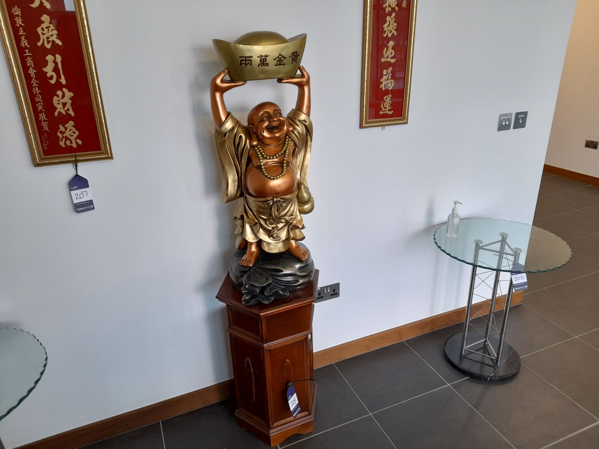 Oriental resin Buddha effigy, mounted on a rose wood effect plinth (1770 H)