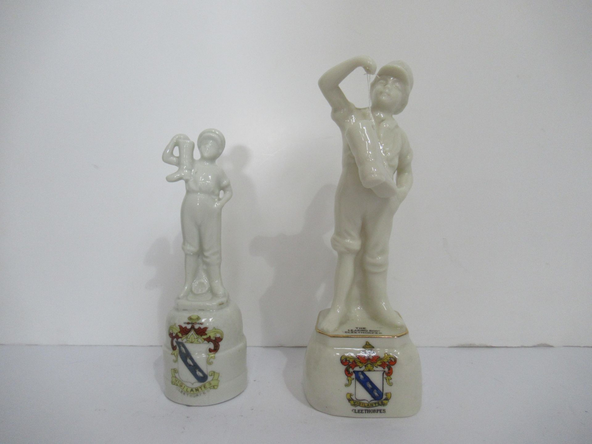 2x Crested China figures of the Leaking Boot' both with Cleethorpes coat of arms