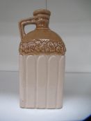 Stone bottle with floral detailing below bottle neck and 'G' stamp on handle