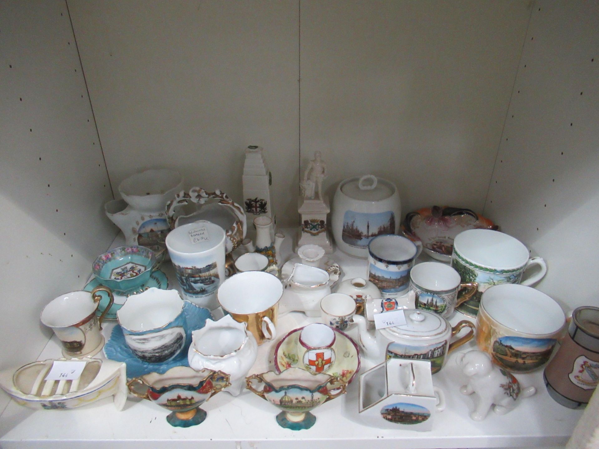 A shelf of assorted crested ceramics, from various locations, including Plymouth, Morcombe, Great Ya