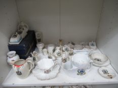 Shelf of assorted crested china adorned with the Grimsby coat of arms