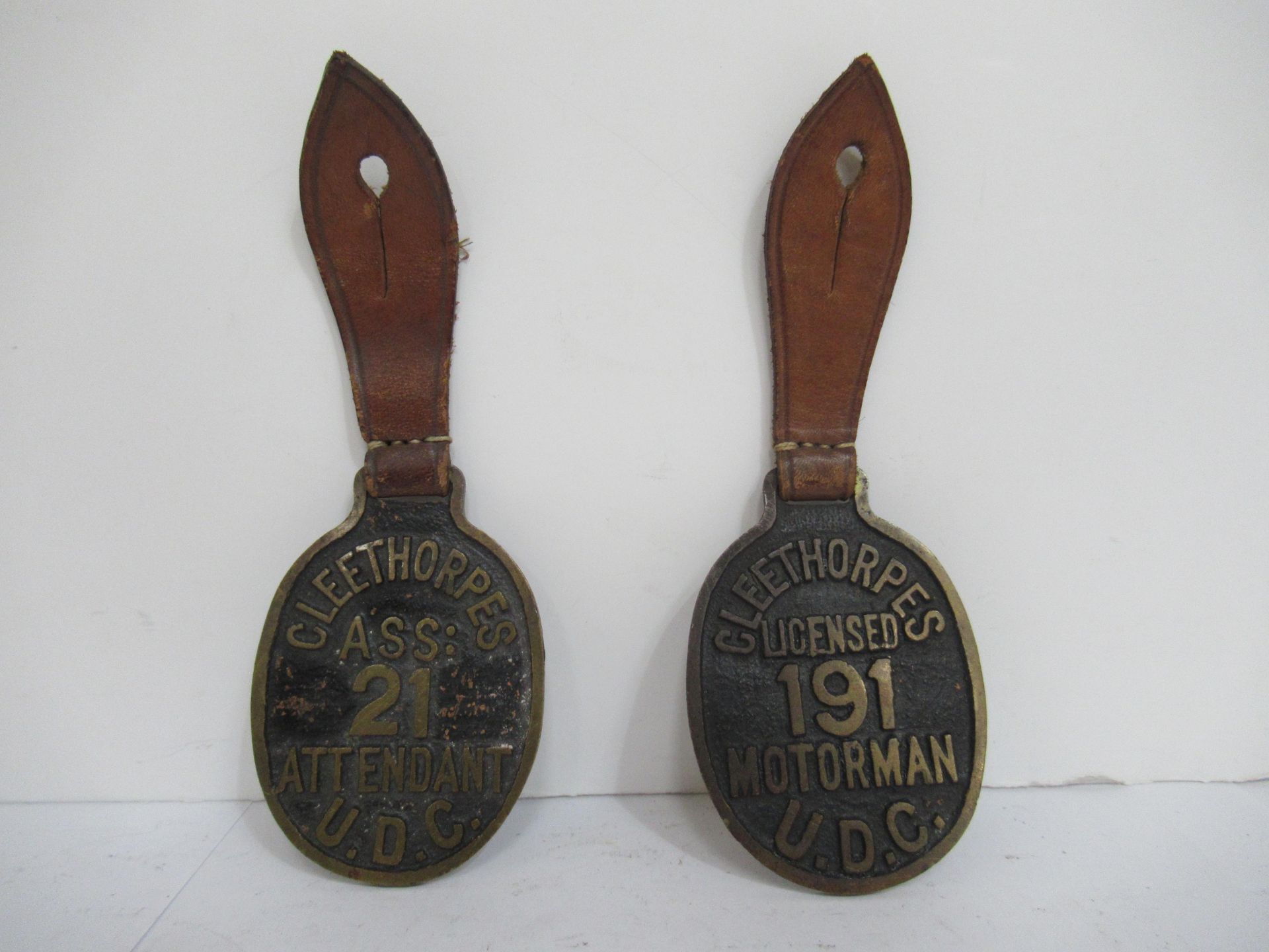 2x Brass Cleethorpes U.D.C 'Attendant' and 'Motorman' wall hanging medallions