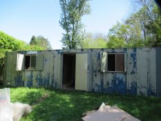 Portable anti-vandal site cabin 30' x 9' with window to each end, plus two windows and a door to one