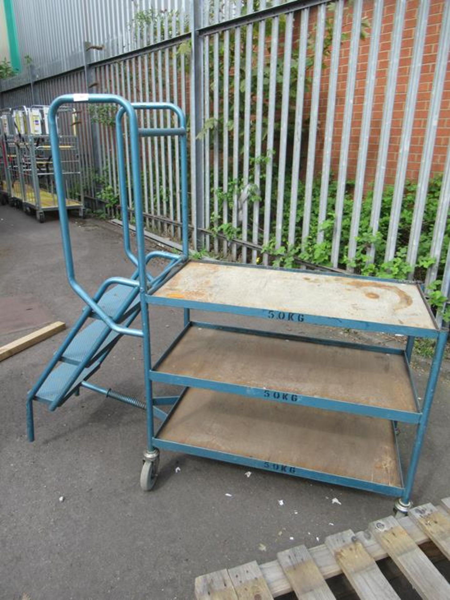 A 3 tier trolley with pull out steps and 2x metal framed tables